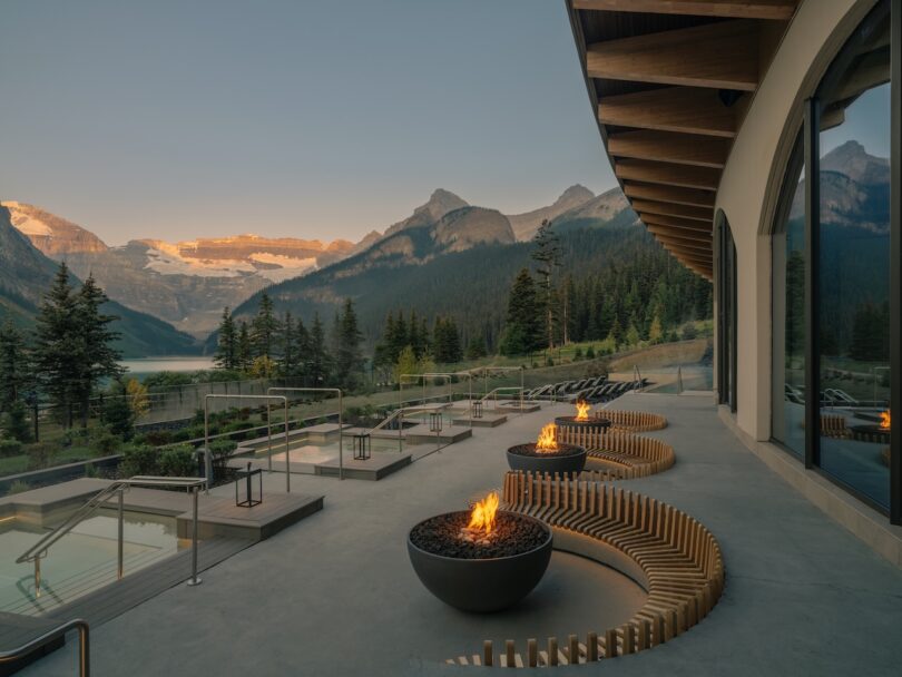 A fire pit on a patio with mountains in the background.