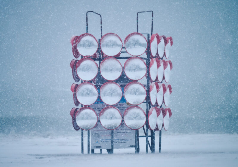 Chimera, mirror art installation on winter beach in snowstorm
