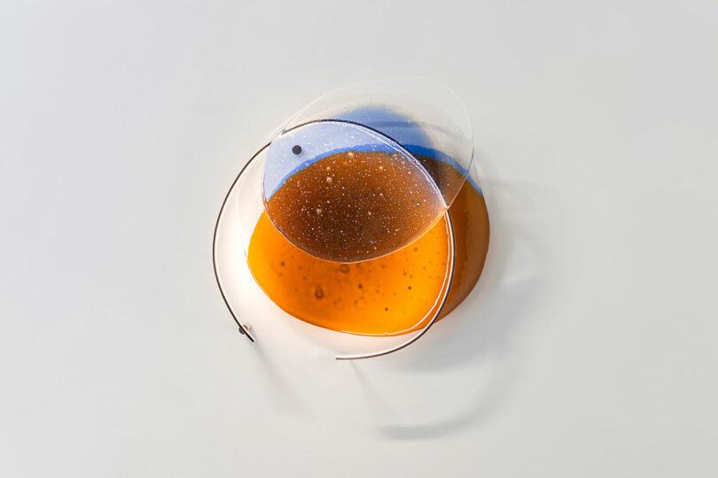 Transparent glass on white wall.