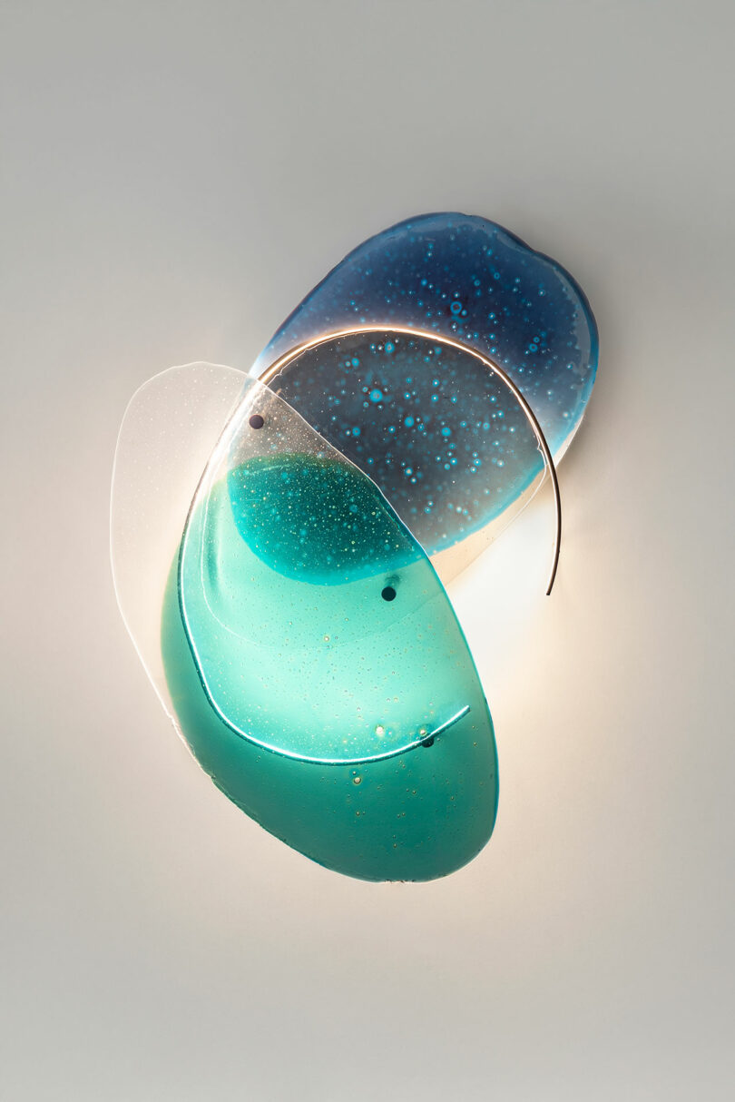 Transparencies of blue glass on a white wall.