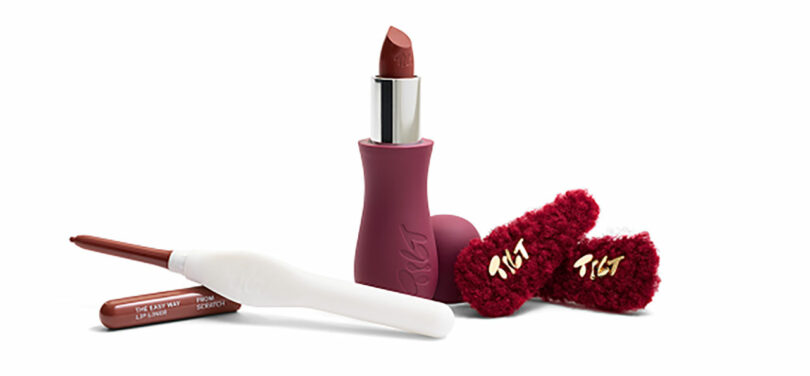 A dark red lipstick, matching lip liner with white cap, and two fuzzy red hair clips labeled "tilt" are displayed on a white background—perfect Valentine's Day gifts for someone special.