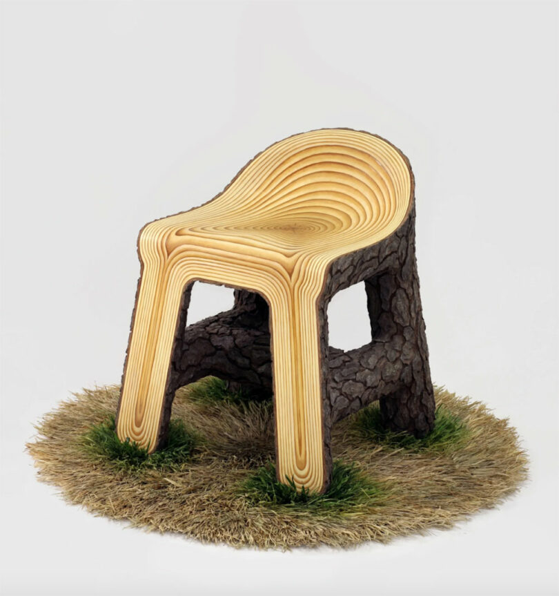 A sculpted chair by Vivian Chiu, made to resemble layered wood and tree bark, sits on a circular patch of grass and dry straw against a plain background.