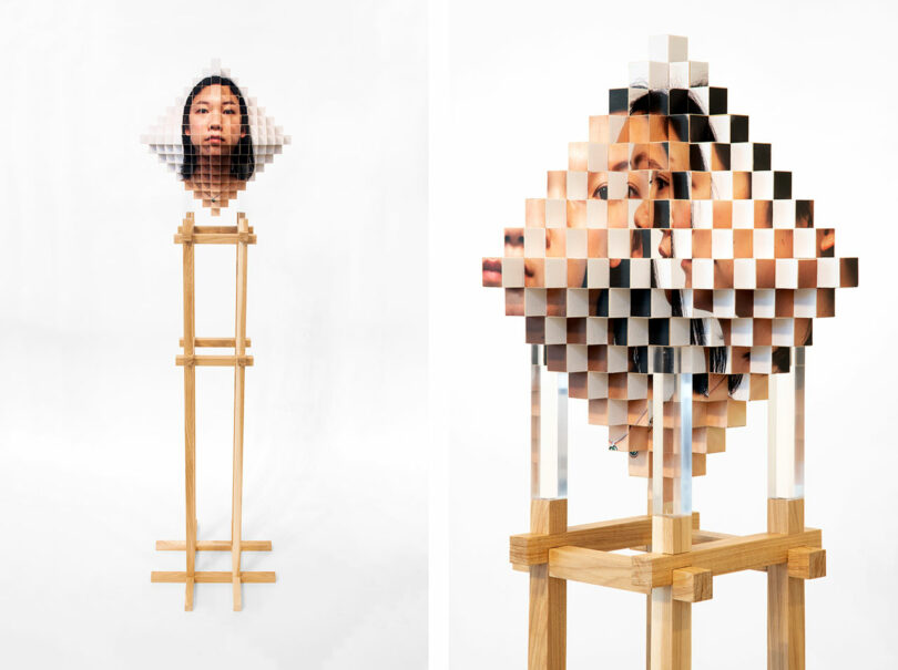 A wooden stand supports a geometric sculpture by Vivian Chiu, made of square blocks that display a fragmented, pixelated image of a woman’s face.