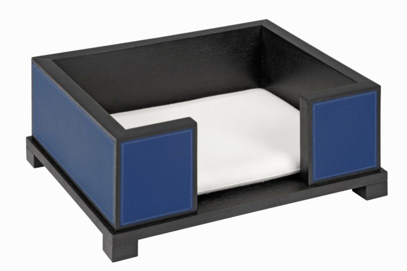 Rectangular pet bed with a black wooden frame, blue side panels, and a white cushion placed inside