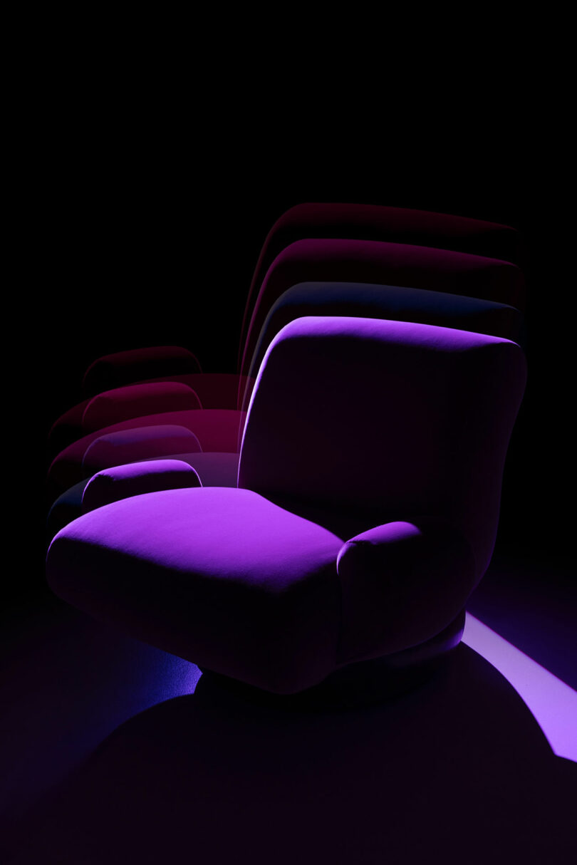 A modern purple armchair from Holly Hunt is shown against a dark background, with multiple overlapping silhouettes suggesting motion or rotation.