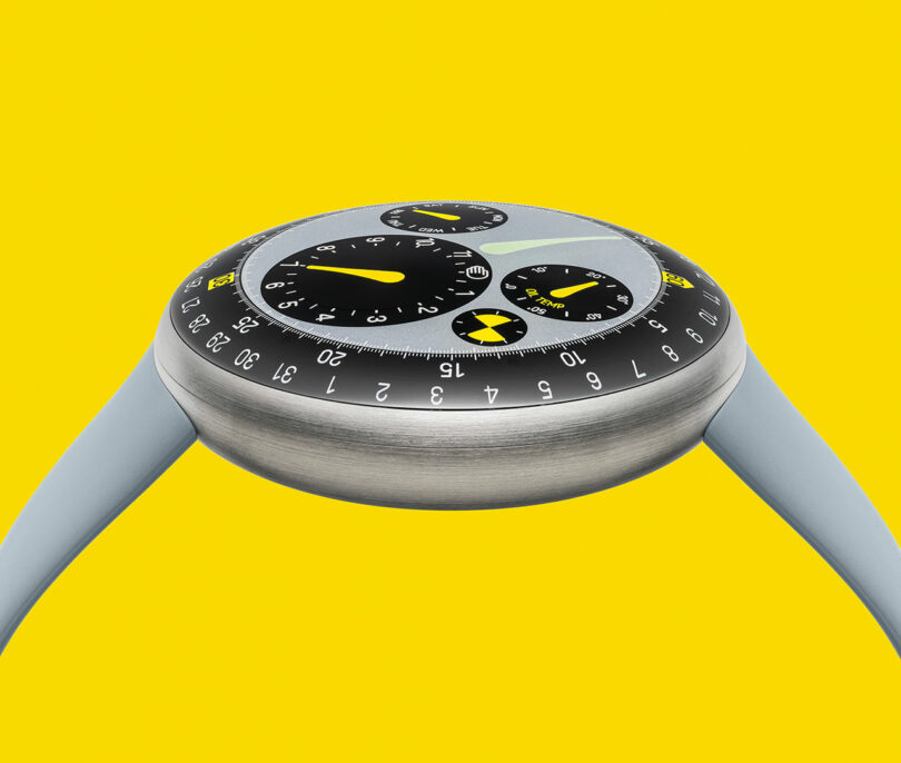 A modern TYPE 3 wristwatch with a round stainless steel case, gray strap, and multiple black and yellow dials stands out against a solid yellow background.