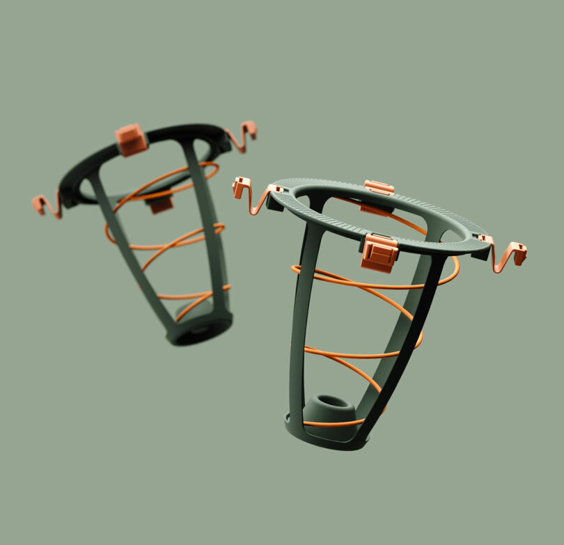 Two cylindrical, open-frame structures with orange wires spiraling from top to bottom, featuring square orange connectors on a muted green background.