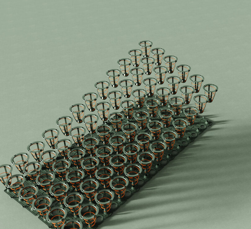 A neatly arranged matrix of metal spring coils is displayed on a light green surface, casting distinct shadows to the right.