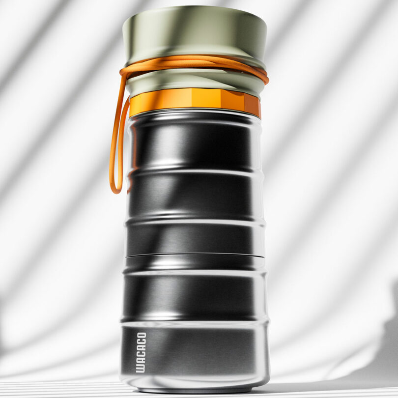 A metallic, ribbed water bottle with a gold cap and orange cord, standing upright against a white background with diagonal shadows. The word "WACACO" is printed near the base.