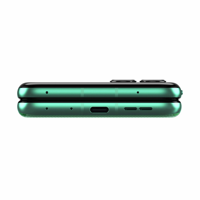 A green smartphone shown from the bottom edge, displaying its charging port, speaker grille, and microphone holes.