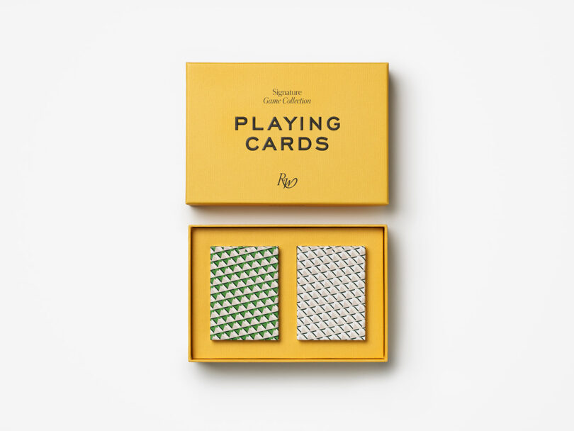 A yellow box labeled "Signature Game Collection Playing Cards" contains two decks of cards with green and blue geometric patterns.