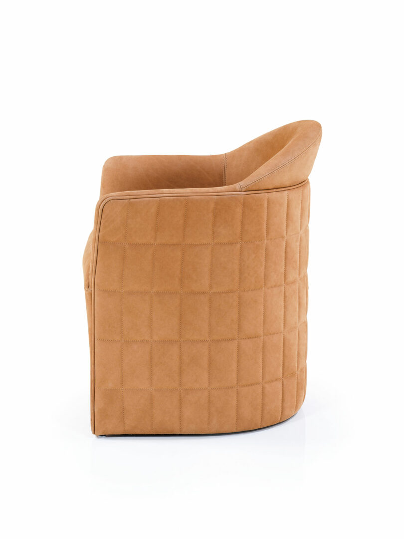 Tan upholstered armchair by Wittmann with a quilted grid pattern on the back and sides, shown from a side angle against a white background.